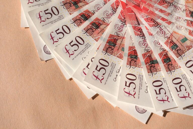 a number of 50 pound notes lying on the table representing how do i pay myself from a limited company